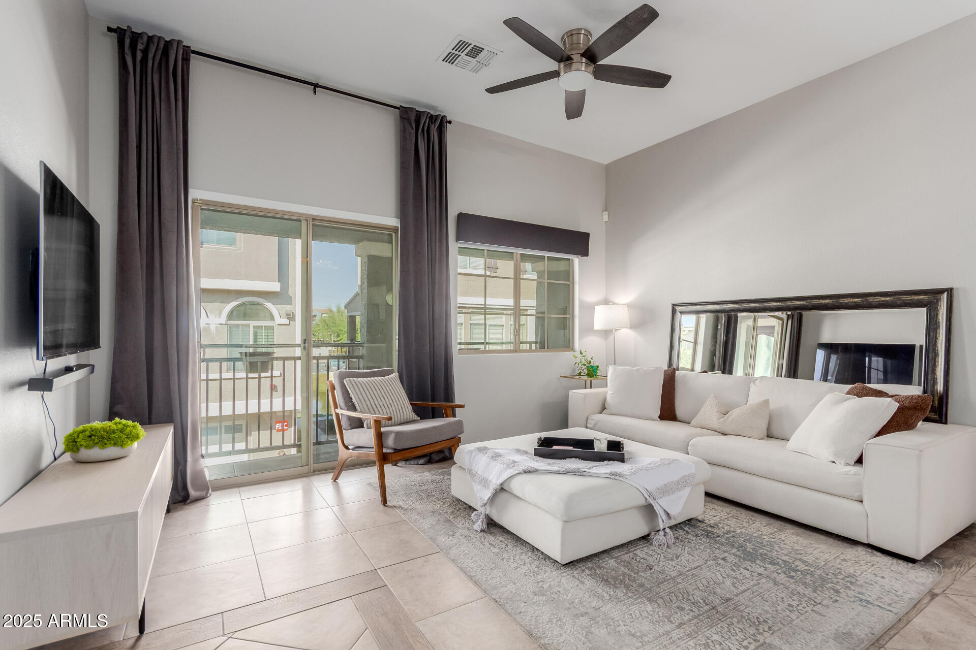 2401 East Rio Salado Parkway, Unit 1106 Tempe, AZ 85288 - Photo 4 of 40 a living room with furniture a flat screen tv and a large window