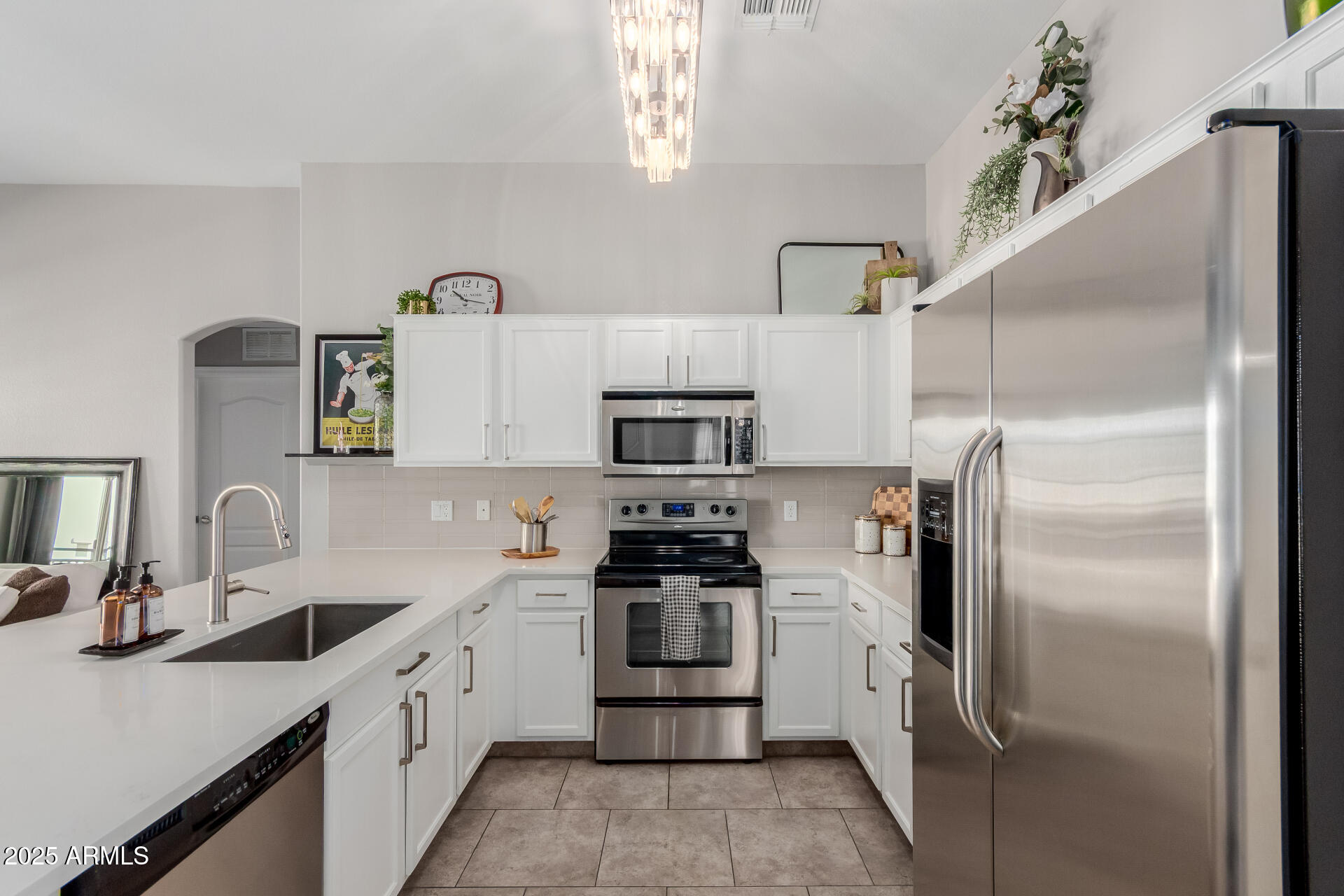 2401 East Rio Salado Parkway, Unit 1106 Tempe, AZ 85288 - Photo 10 of 40 a kitchen with cabinets a sink and stainless steel appliances