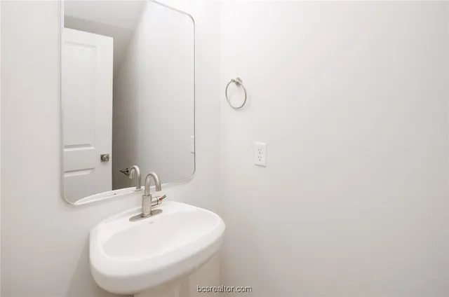 a bathroom with a sink and mirror