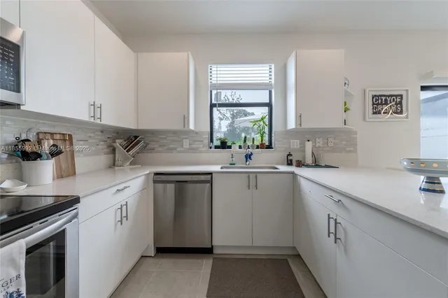 a kitchen with sink cabinets and window