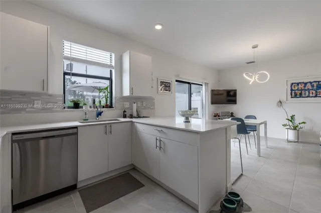 a kitchen with sink cabinets and window