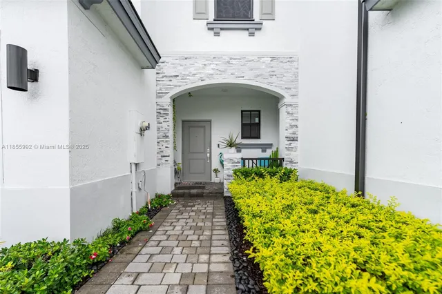 a front view of a house with garden