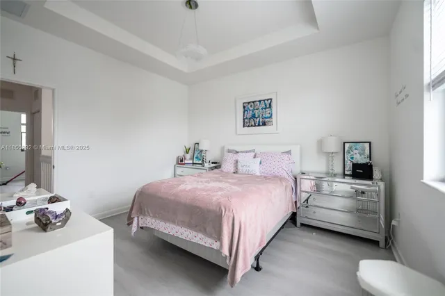 a bedroom with a bed and a large mirror