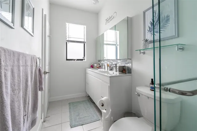 a view of a city with lots of residential buildings ocean and mountain view