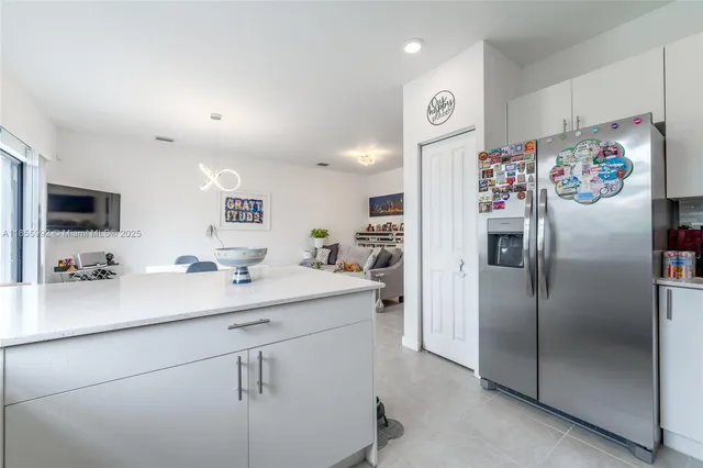 a kitchen with a refrigerator and a sink