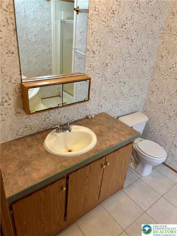 8568 Deer Road Slatington, PA 18080 - Photo 15 of 37 a bathroom with a granite countertop sink and a mirror