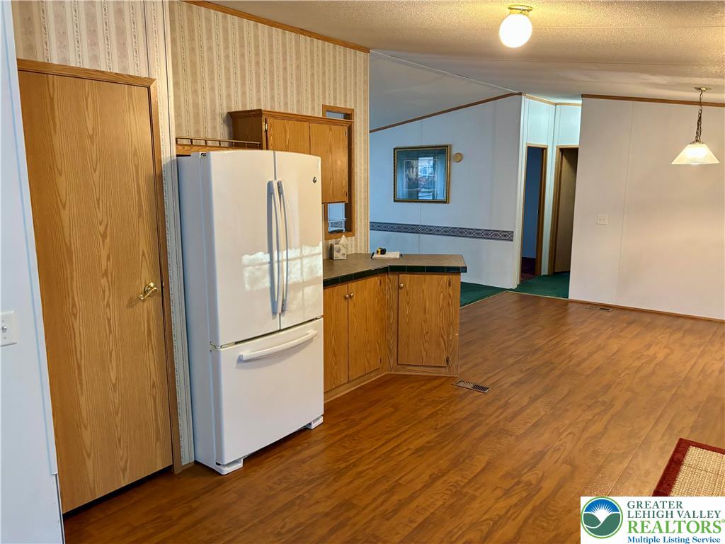 8568 Deer Road Slatington, PA 18080 - Photo 5 of 37 a kitchen with granite countertop a refrigerator and a sink