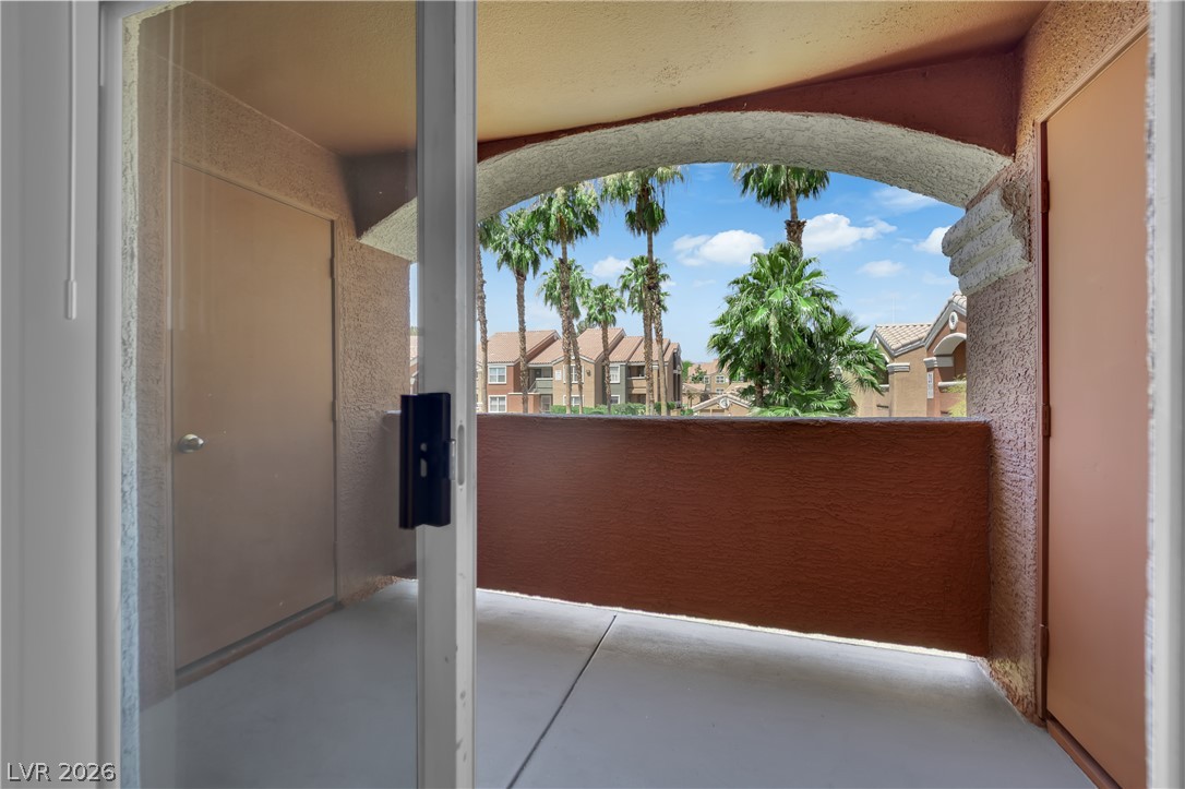 8101 West Flamingo Road, Unit 2152 Las Vegas, NV 89147 - Photo 23 of 45 An inviting private patio balcony offers a pleasant outdoor retreat with tropical landscaping views.