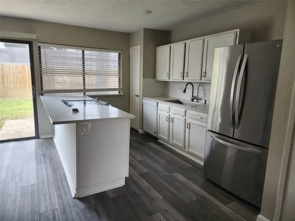 a kitchen with stainless steel appliances granite countertop a refrigerator a sink and a stove
