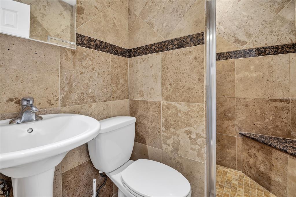 13440 1st Street East Madeira Beach, FL 33708 - Photo 23 of 44 a bathroom with a sink and a toilet