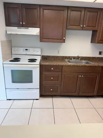 a kitchen with a cabinets and a stove top oven