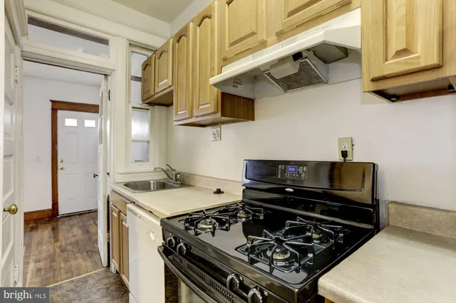 a kitchen with stainless steel appliances granite countertop a stove and a sink