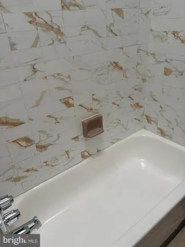 a bathroom with a bathtub and sink