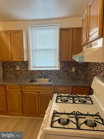 a kitchen with a stove and a sink