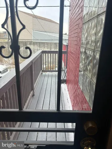a view of a balcony with wooden floor