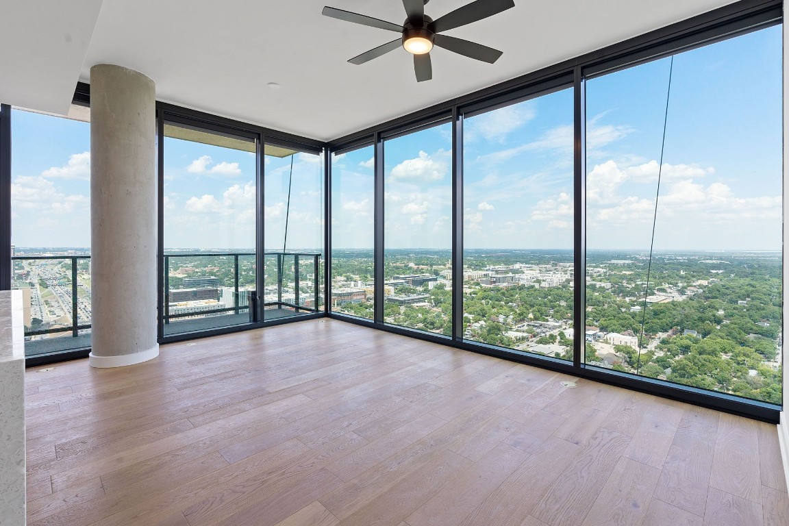 84 East Avenue, Unit 3404 Austin, TX 78701 - Photo 11 of 40 a view of an empty room with wooden floor and a large window