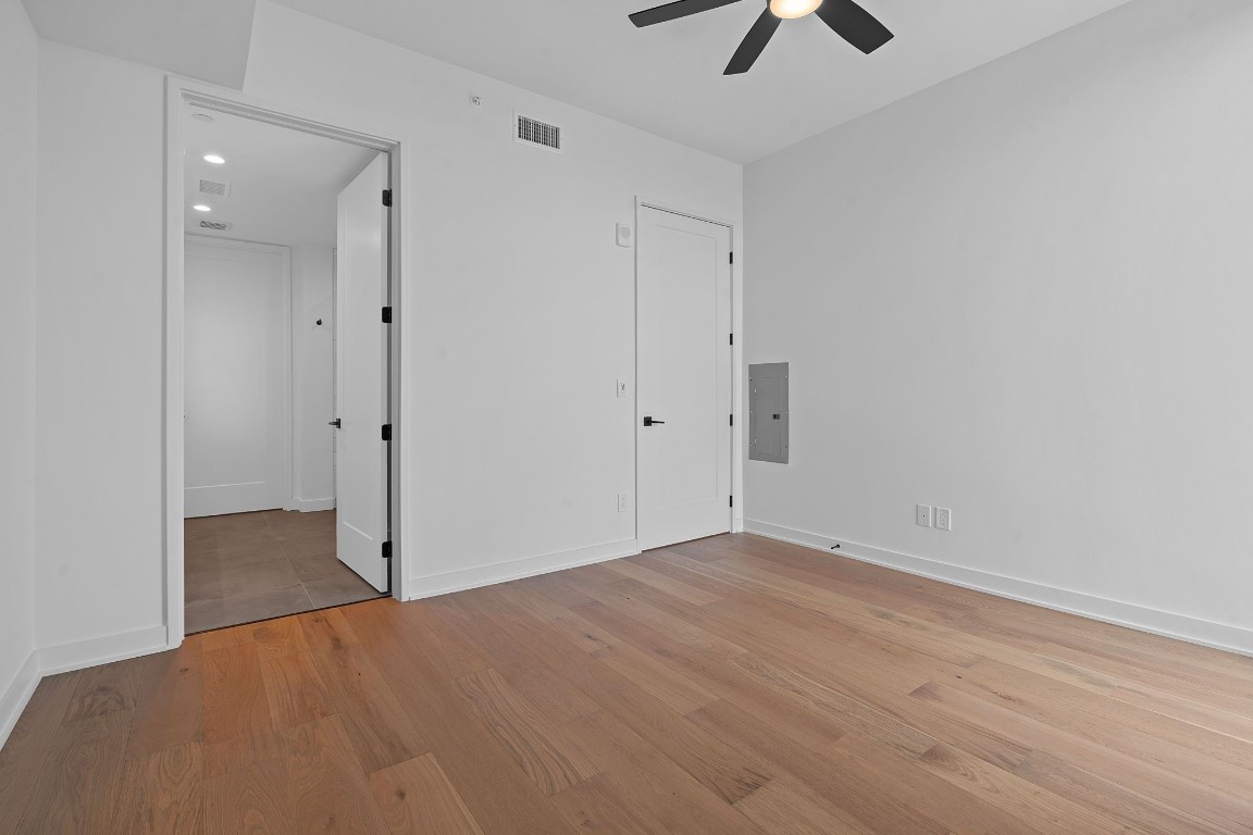84 East Avenue, Unit 3404 Austin, TX 78701 - Photo 14 of 40 an empty room with chandelier fan