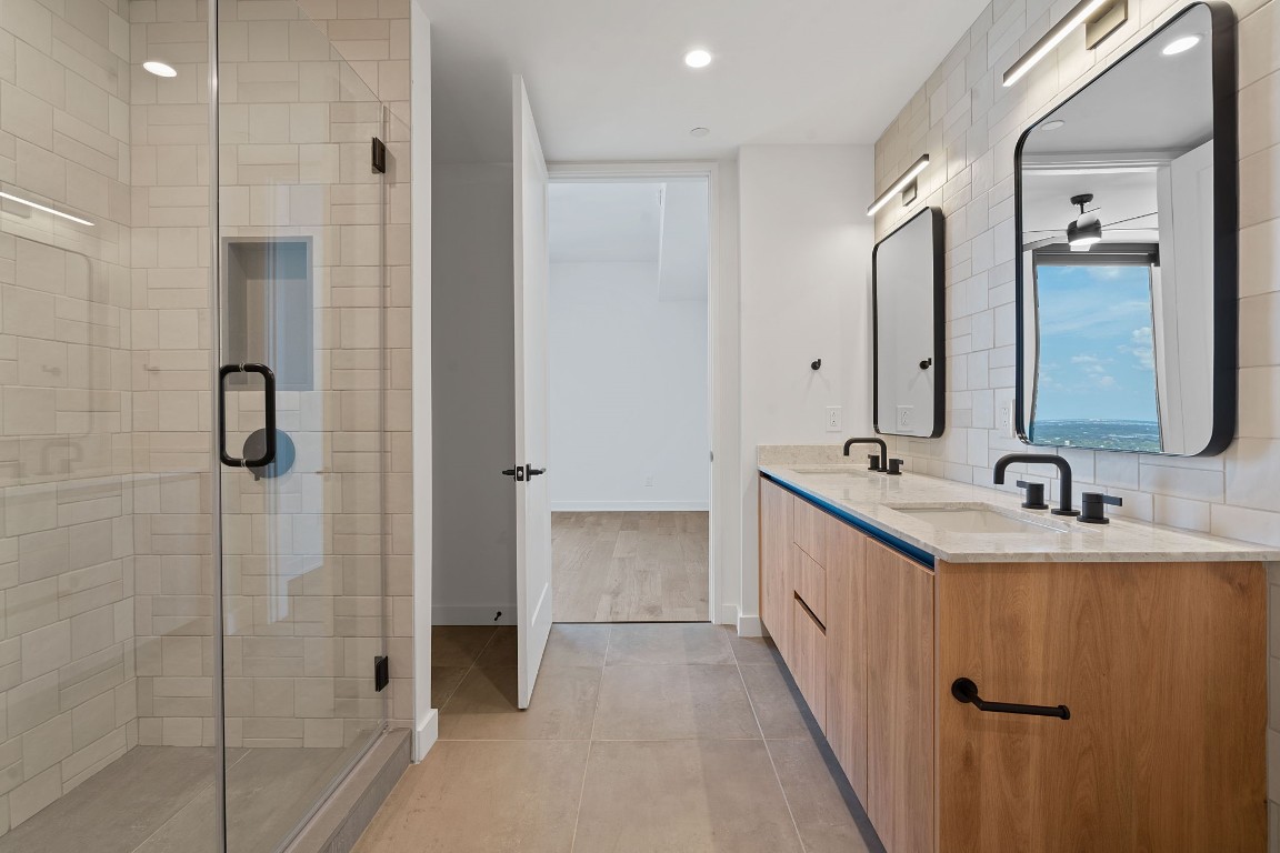 84 East Avenue, Unit 3404 Austin, TX 78701 - Photo 18 of 40 a bathroom with a double vanity sink mirror and shower