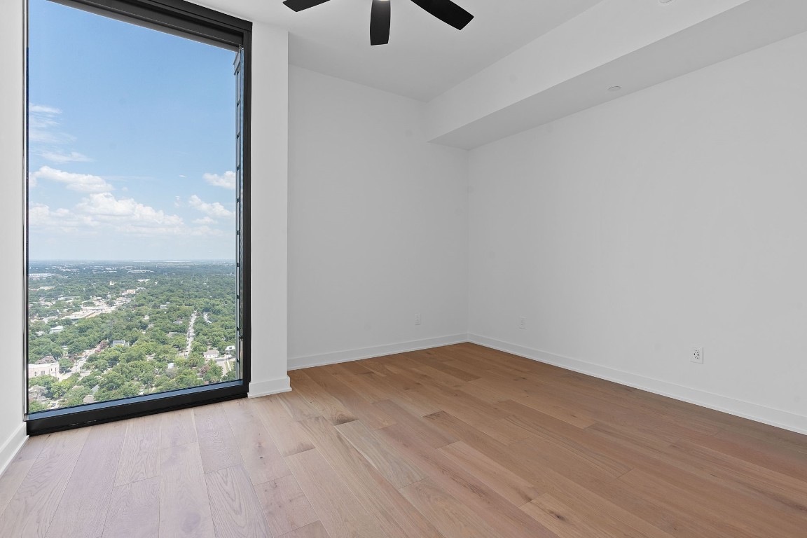 84 East Avenue, Unit 3404 Austin, TX 78701 - Photo 19 of 40 a view of an empty room with wooden floor and windows