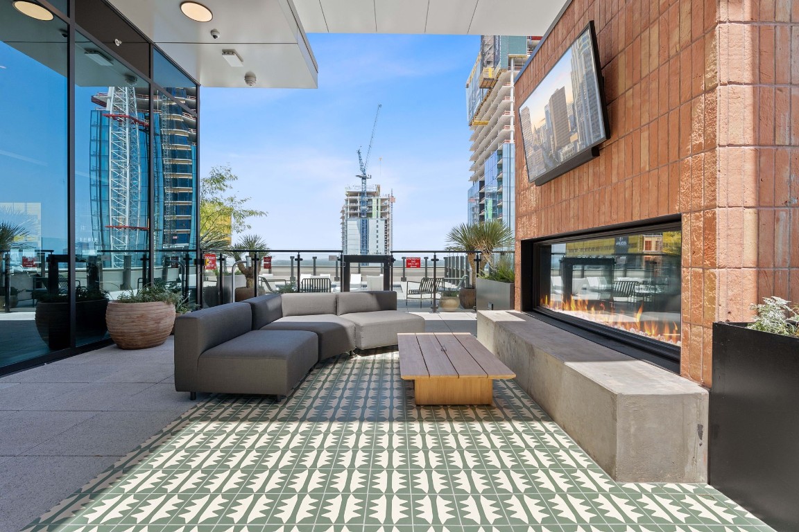 84 East Avenue, Unit 3404 Austin, TX 78701 - Photo 32 of 40 a living room with furniture and a fireplace
