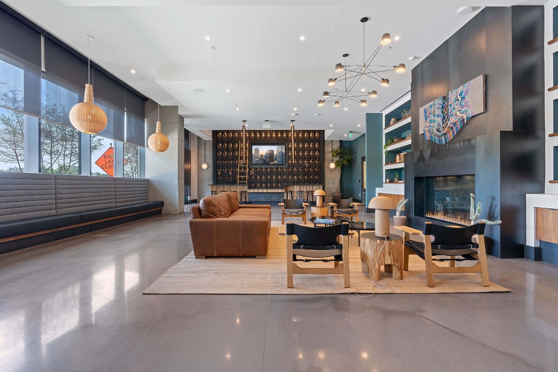 84 East Avenue, Unit 3404 Austin, TX 78701 - Photo 37 of 40 a living room with fireplace furniture and a chandelier