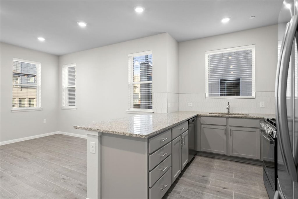 9015 Cattle Baron Path, Unit 705 Austin, TX 78747 - Photo 9 of 35 a kitchen with sink and window