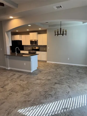 a view of kitchen with kitchen island microwave and stove