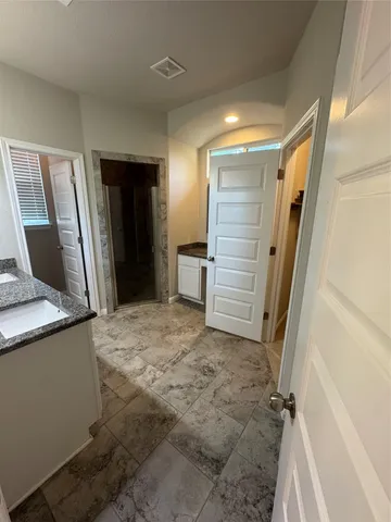 a view of walk in closet with empty room