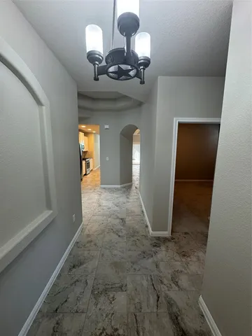 a view of a hallway with a chandelier