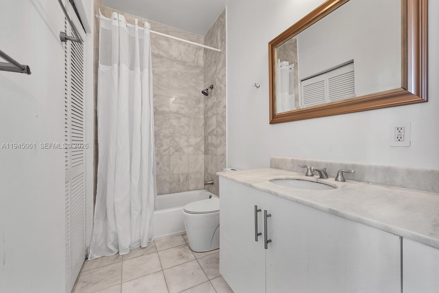 725 Northeast 22nd Street, Unit PH2B Miami, FL 33137 - Photo 20 of 21 a bathroom with a granite countertop sink toilet and shower