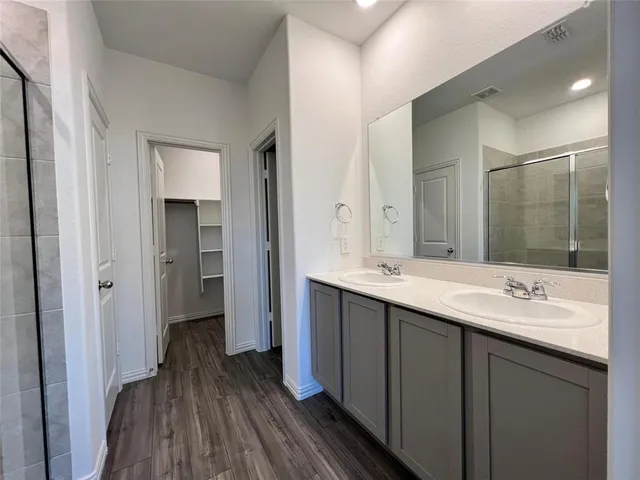 a bathroom with a double vanity sink and mirror