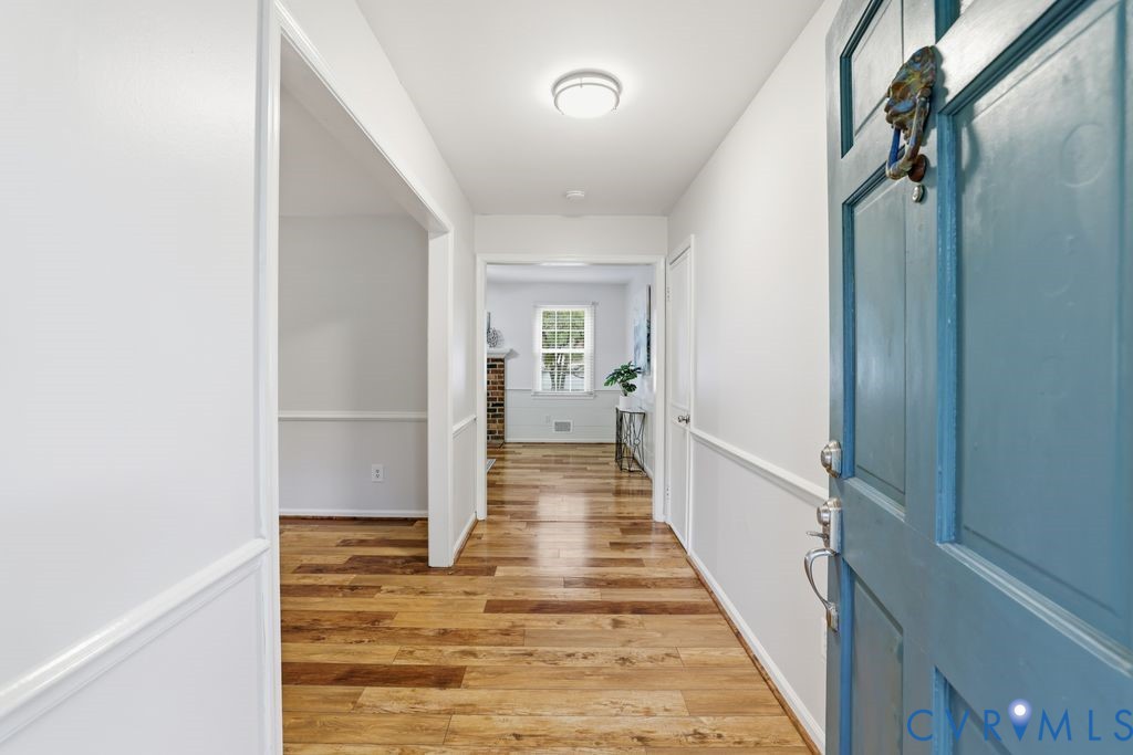 161 Arkwright Road Chesterfield, VA 23236 - Photo 6 of 43 a view of a hallway with wooden floor and staircase
