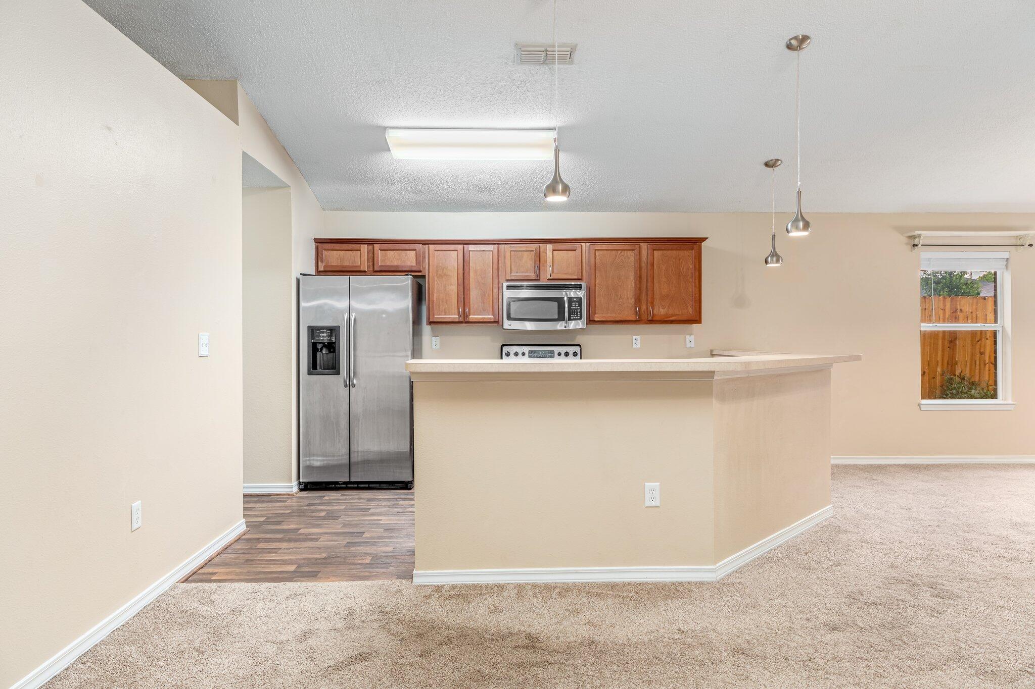 273 Limestone Circle Crestview, FL 32539 - Photo 11 of 36 a kitchen with stainless steel appliances granite countertop a refrigerator a sink a stove and oven