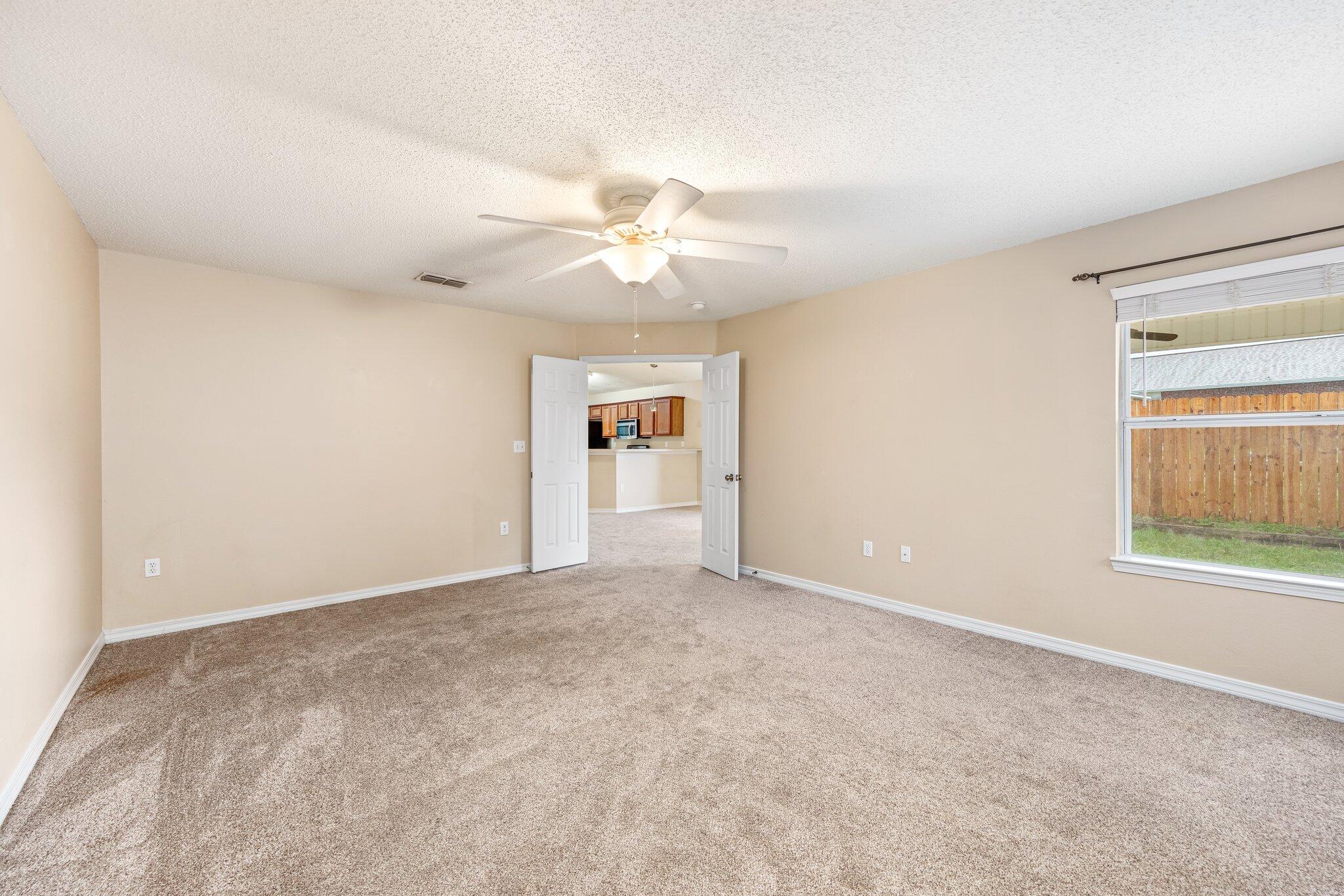 273 Limestone Circle Crestview, FL 32539 - Photo 19 of 36 an empty room with windows and ceiling fan