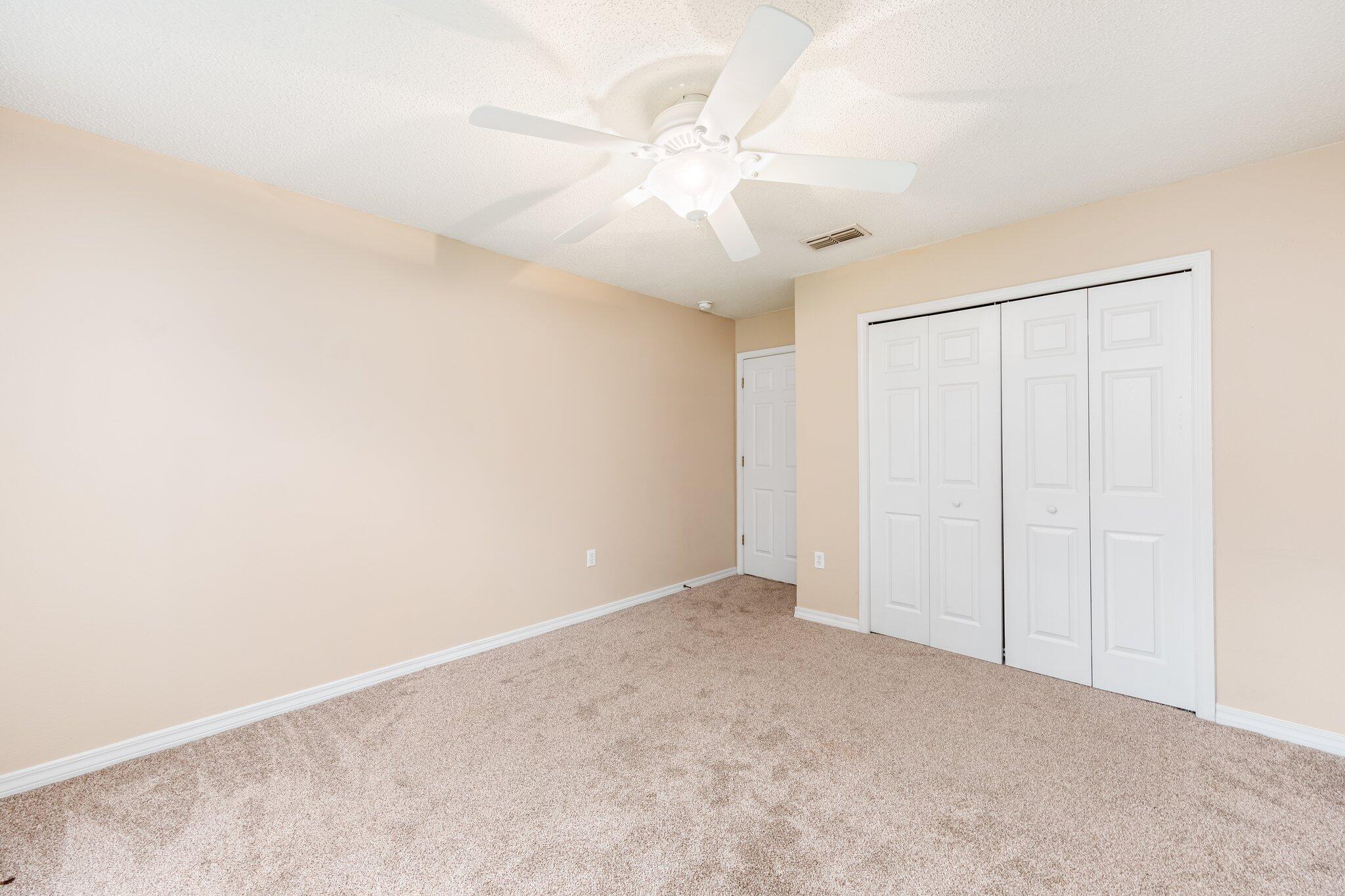 273 Limestone Circle Crestview, FL 32539 - Photo 26 of 36 an empty room with a ceiling fan and a window