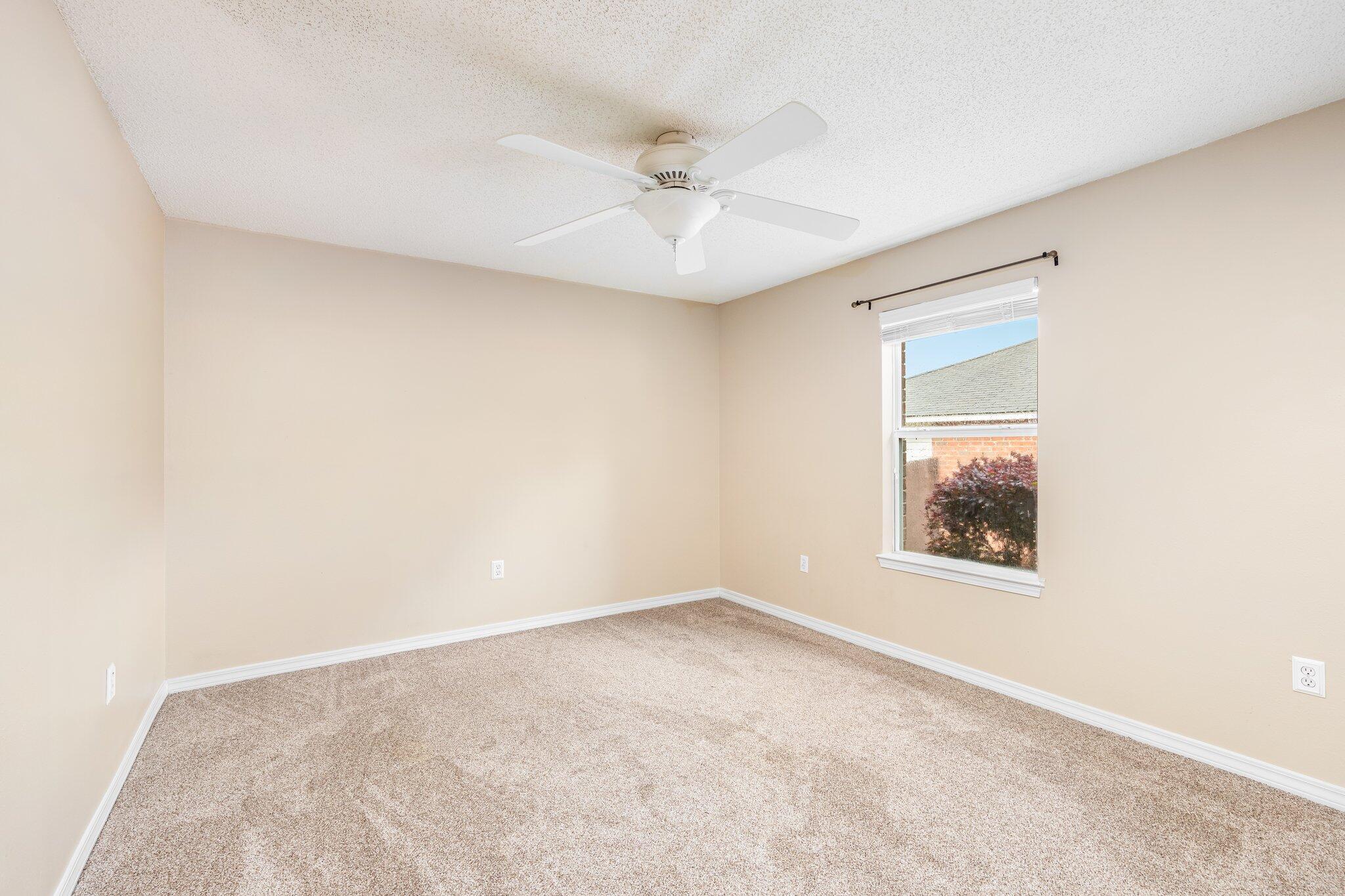 273 Limestone Circle Crestview, FL 32539 - Photo 29 of 36 an empty room with a window and a ceiling fan