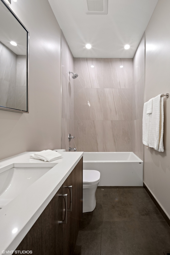 4448 South Drexel Boulevard, Unit A Chicago, IL 60653 - Photo 13 of 16 a bathroom with a sink a toilet and bathtub