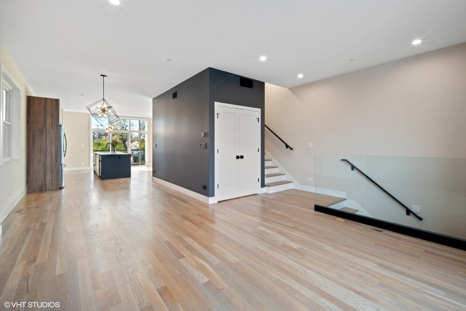 4448 South Drexel Boulevard, Unit A Chicago, IL 60653 - Photo 5 of 16 a view of a kitchen with wooden floor and a ceiling fan