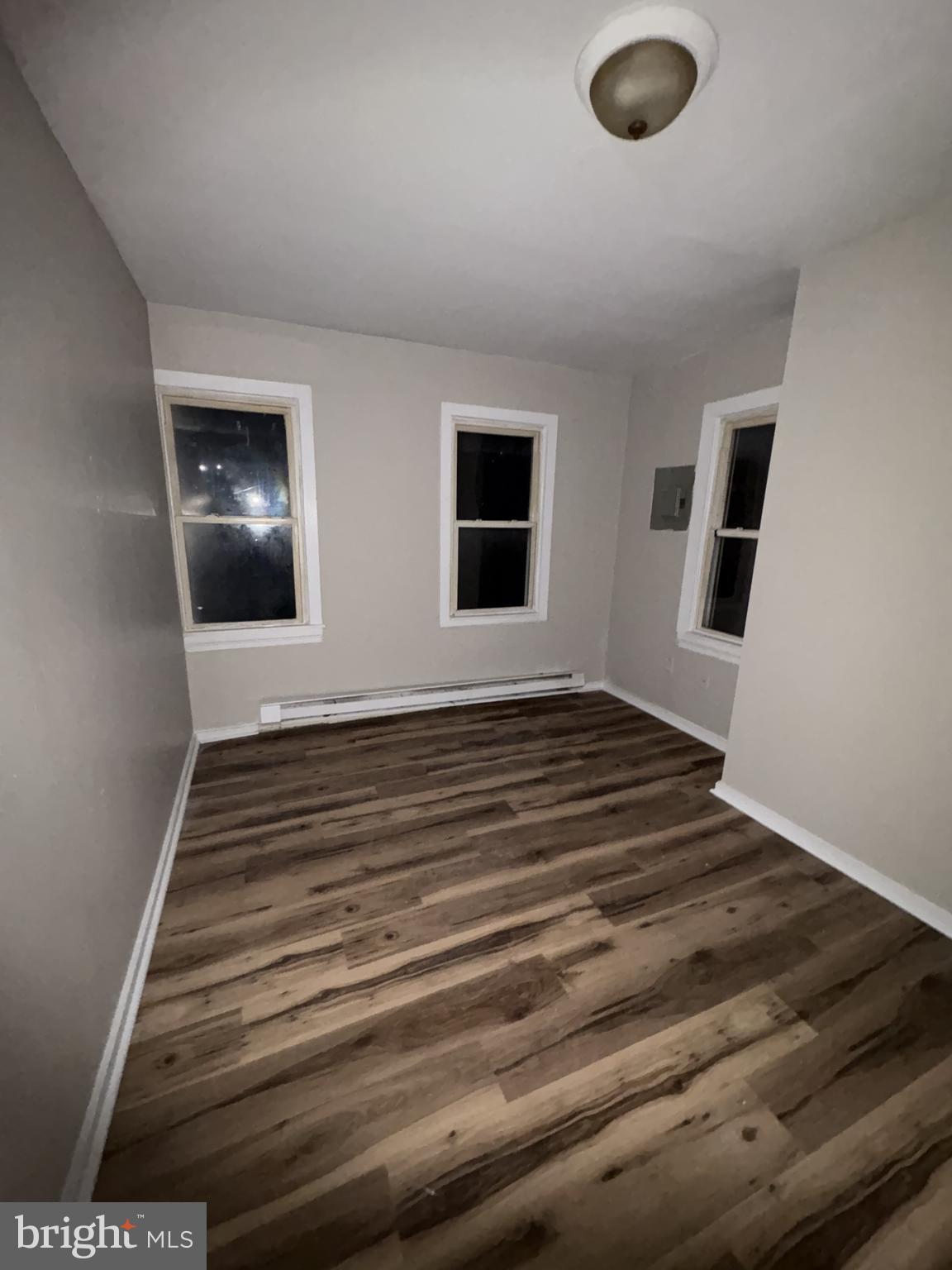 85 Union Street Salem, NJ 08079 - Photo 11 of 14 a view of an empty room with wooden floor and windows