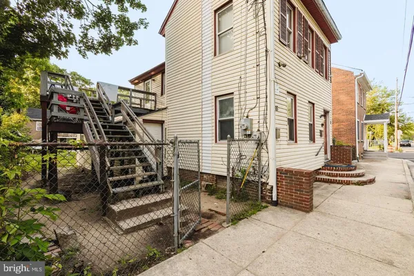 a view of a house with stairs and a yard