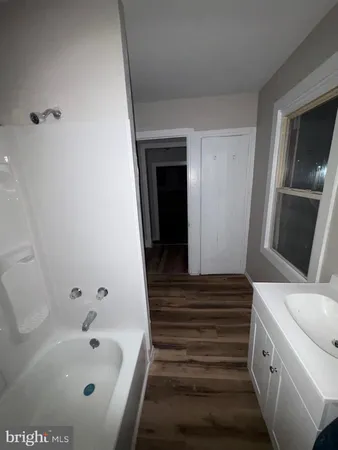 a bathroom with a bathtub and shower