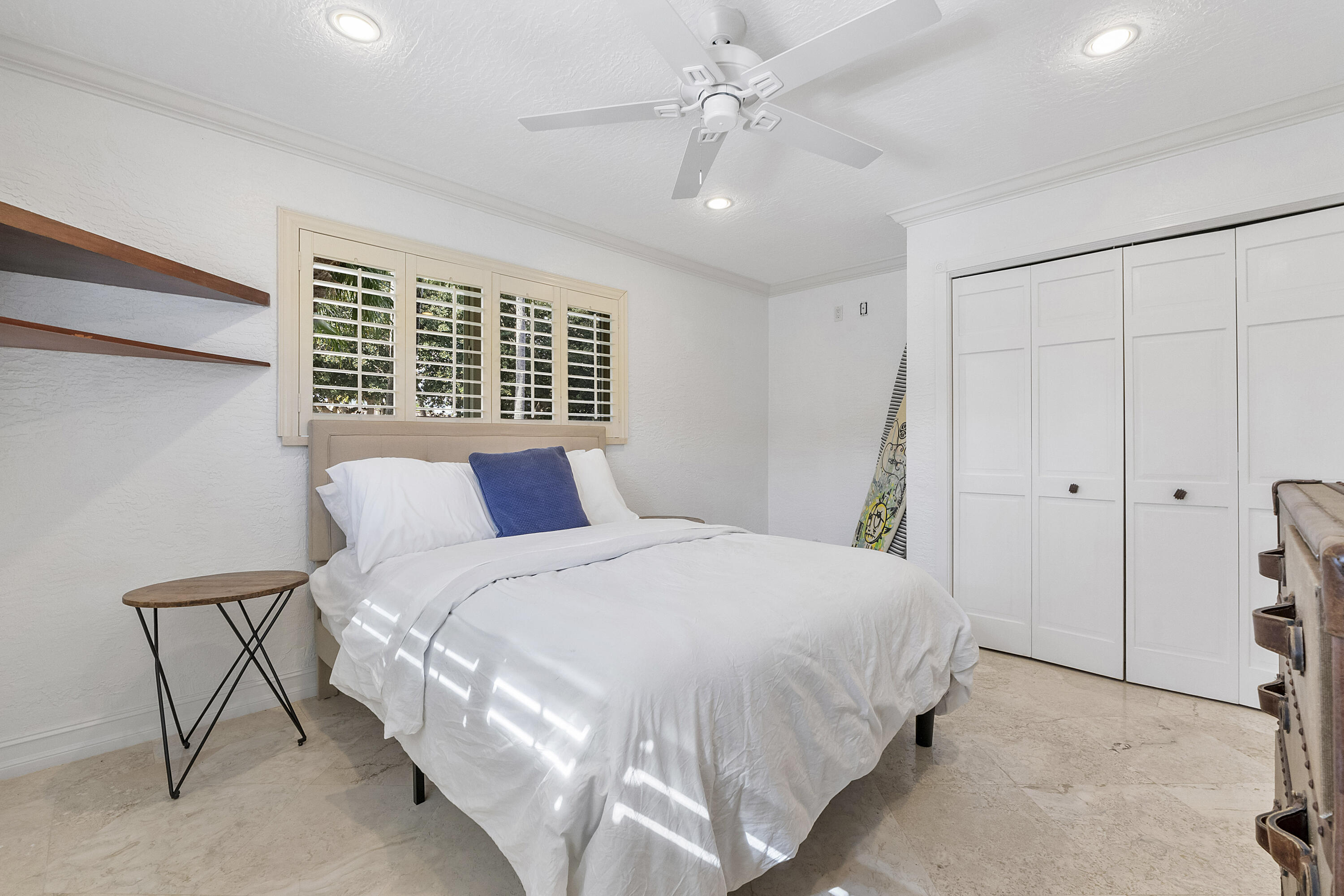 120 Southwest 8th Avenue Boca Raton, FL 33486 - Photo 20 of 38 a bedroom with a large bed and a ceiling fan