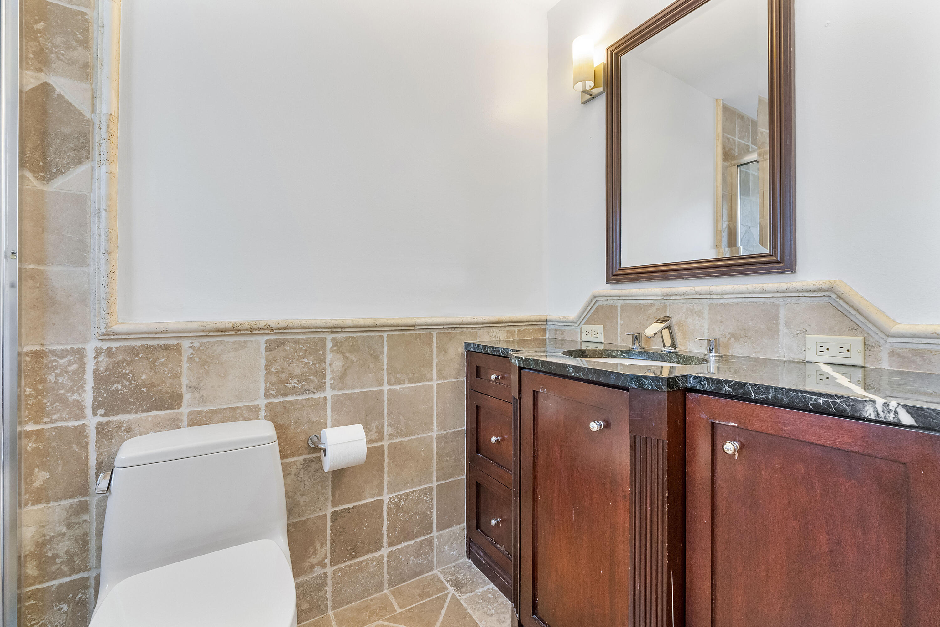 120 Southwest 8th Avenue Boca Raton, FL 33486 - Photo 25 of 38 a bathroom with a granite countertop sink a mirror and a