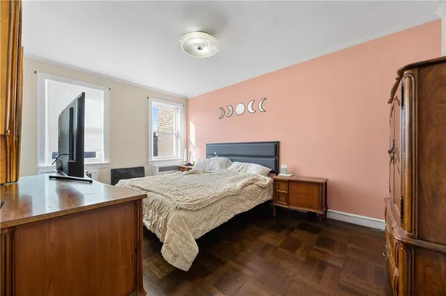 a bedroom with a bed and a large window