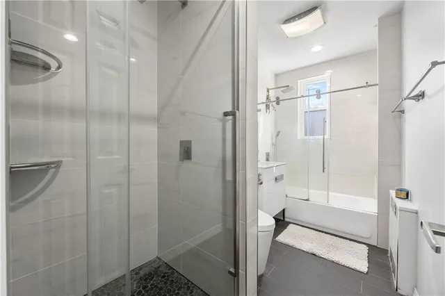a bathroom with a shower and a glass door