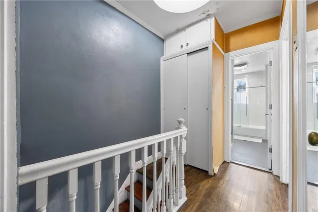 a view of hallway with wooden floor