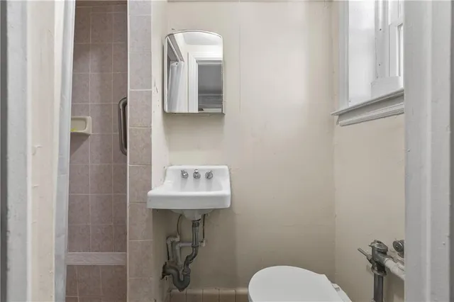 a bathroom with a toilet sink and mirror