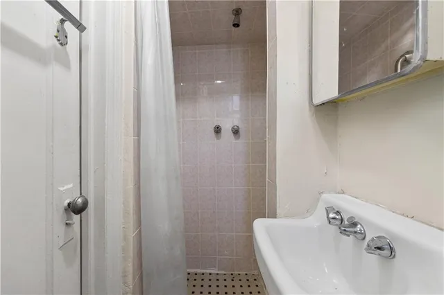 a view of storage and utility room with refrigerator and washer