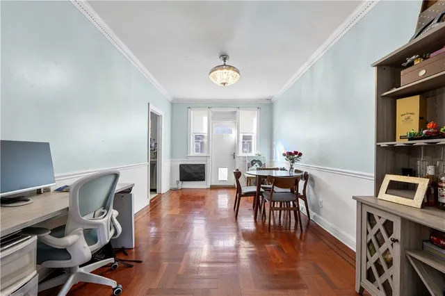 a view of a workspace with furniture and wooden floor
