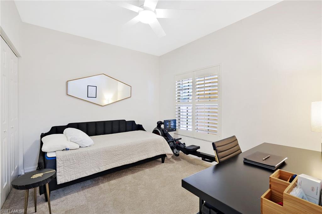 4455 Botanical Pl Circle, Unit 204 Naples, FL 34112 - Photo 16 of 26 a bedroom with furniture and a window